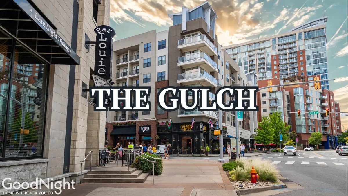 An exterior scene showcasing Bar Louie, The Gulch sign, modern apartment buildings, and lively pedestrian activity, with people dining outdoors and exploring the area.